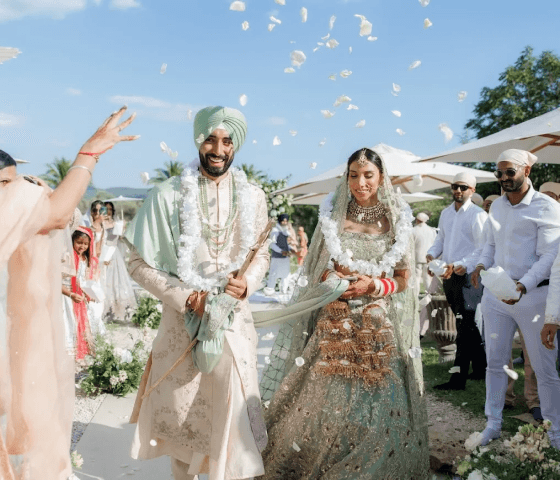 Guests showering the wedding couple with flower petals